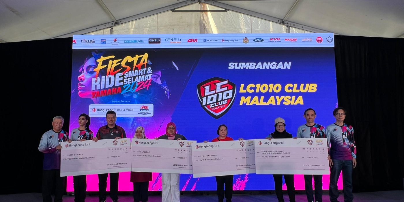 Cheque presentation on stage from LC1010 Club Malaysia to NGO